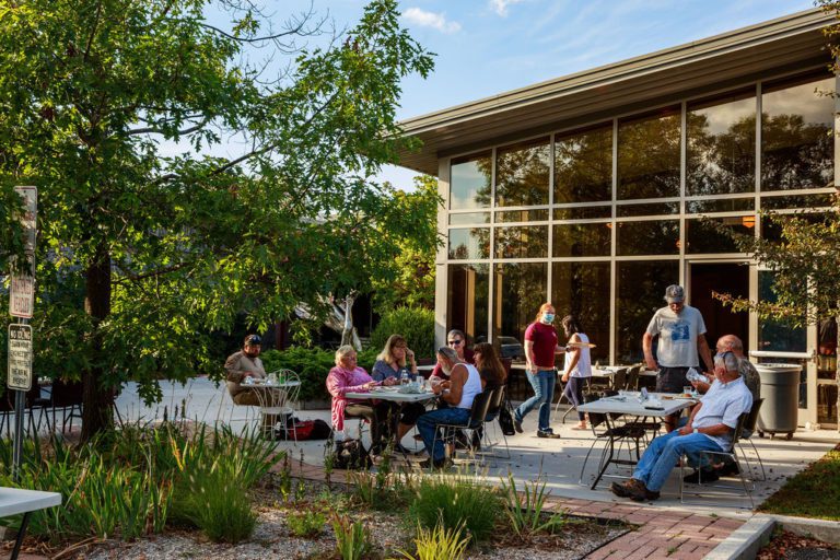 Guests eating outside on the patio for the Community Supper