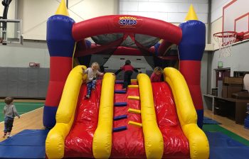 Children playing on an inflatable bounce house slide
